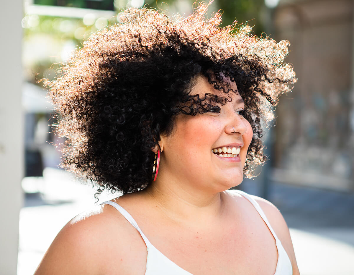 smiling-adult-plump-female-with-afro-hairstyle-loo-2025-12-19-17-59-00-utc (1)