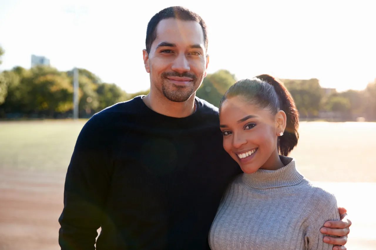 young couple smiling at camera in brooklyn close utc